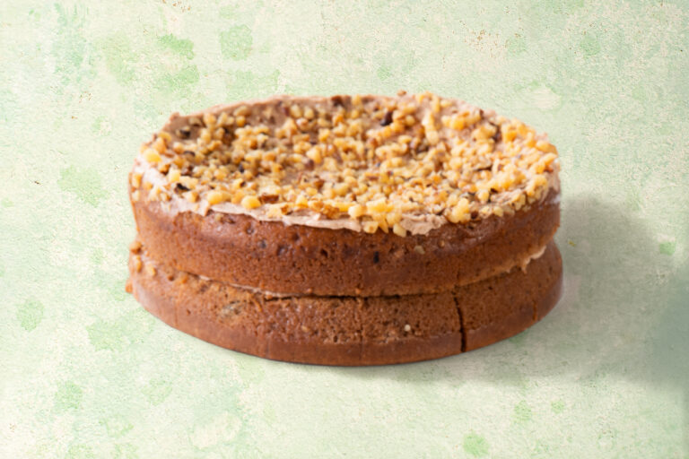 Vegan banana and cinnamon cake with chopped walnut topping