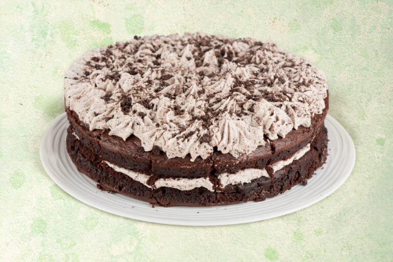 Vegan cookies and cream cake with chocolate cookie topping.